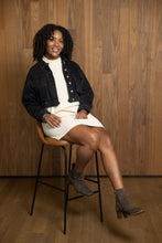 Load image into Gallery viewer, Mock Neck Dress in Beige on Seated Model, Front View. Stylized with a Cropped Jean Jacker
